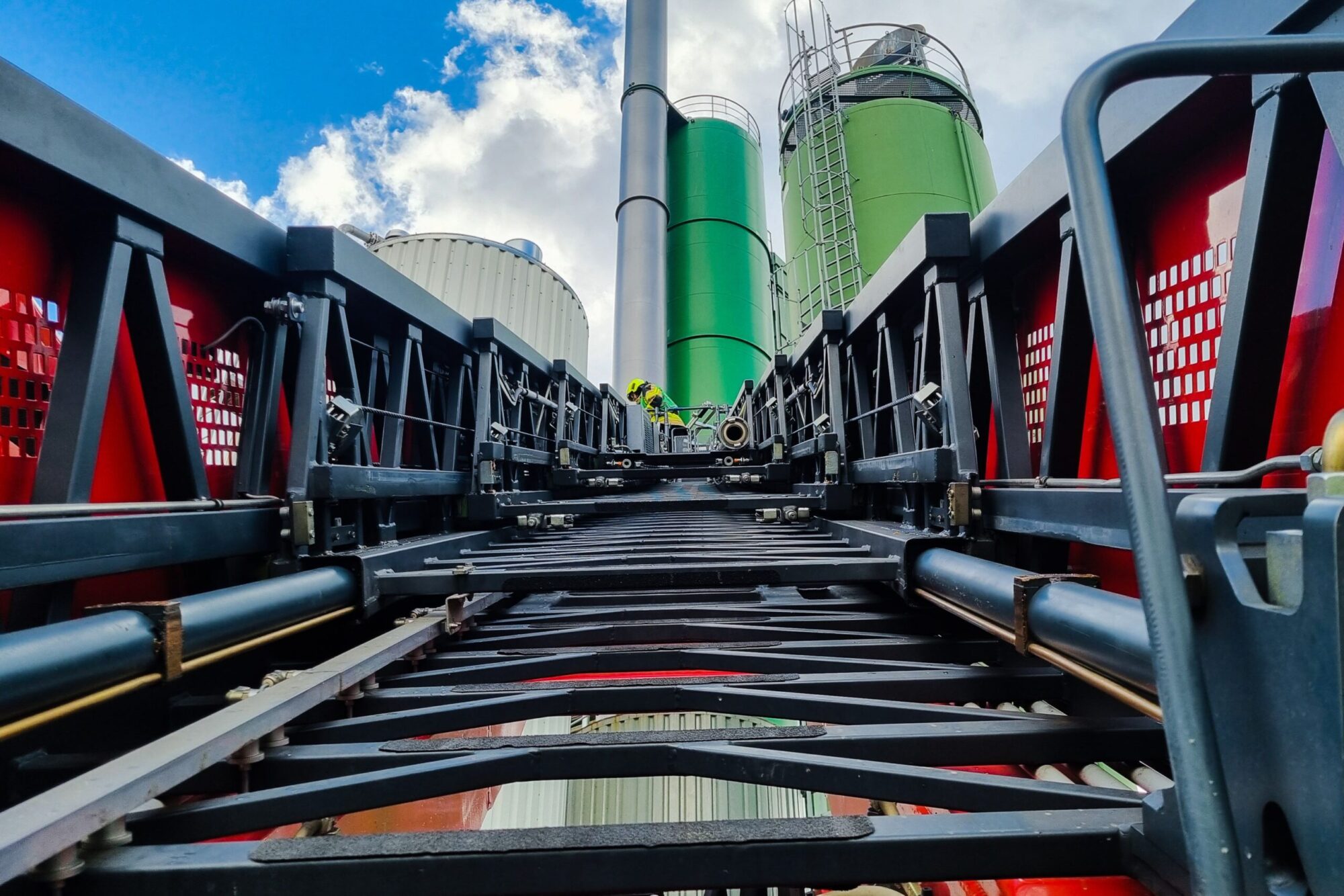 A low angle of a staircase against buildings in a factory